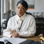 Confident businesswoman working at her desk in a modern office setting, focusing on an important task.